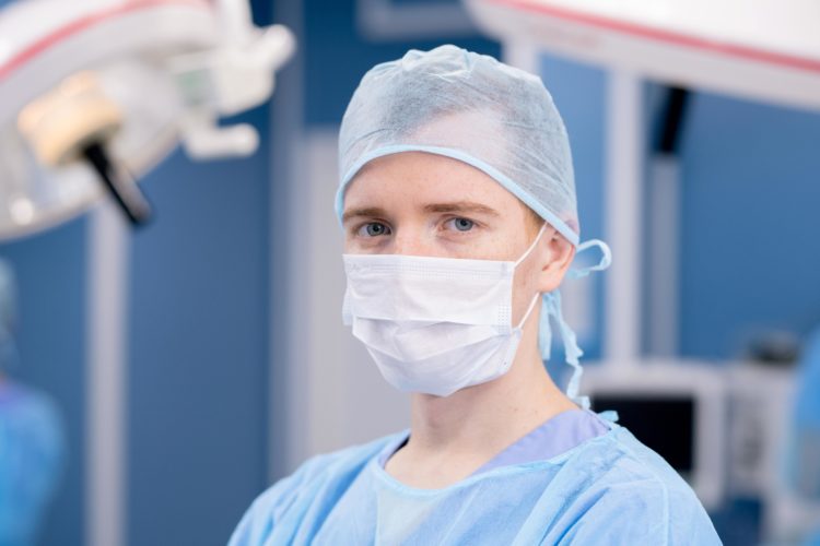 young-intern-or-surgeon-in-protective-mask-and-uni-N8QZXAY-min